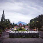 Einfahrt zum Uni-Gelände und Blick Richtung Hauptgebäude mit Merapi im Hintergrund.